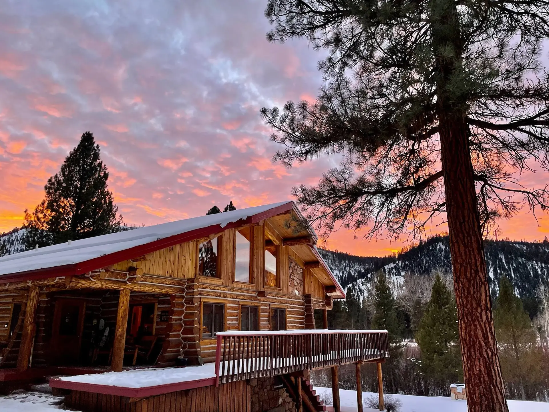The lodge in the snow under a pink sunset sky